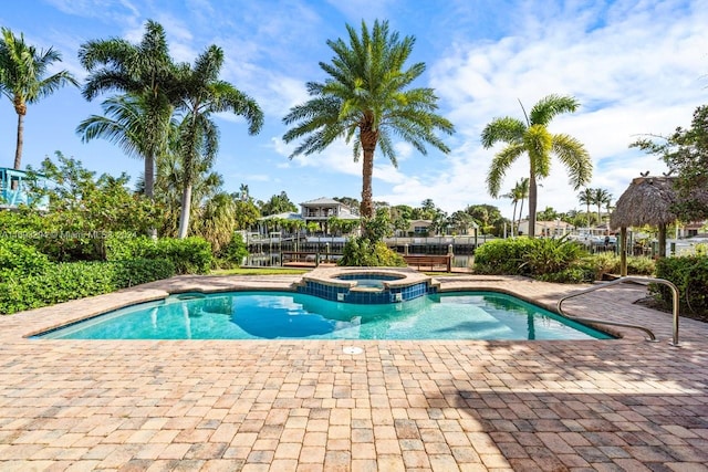 view of swimming pool with a patio area and an in ground hot tub