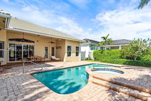 view of swimming pool with ceiling fan, a patio, and an in ground hot tub