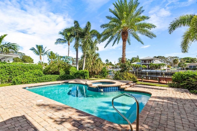 view of swimming pool with an in ground hot tub and a patio area