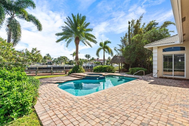 view of pool featuring an in ground hot tub and a patio