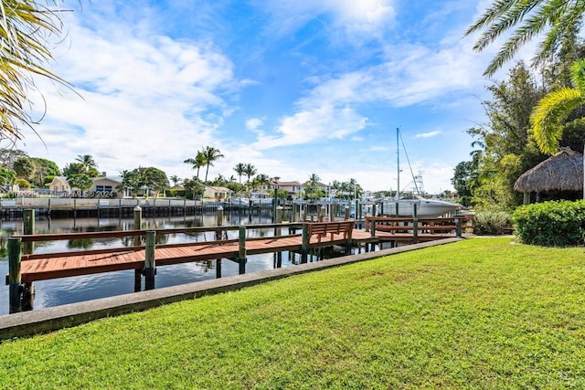 dock area with a water view and a lawn