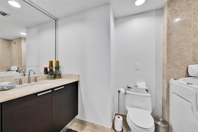 bathroom featuring vanity and toilet