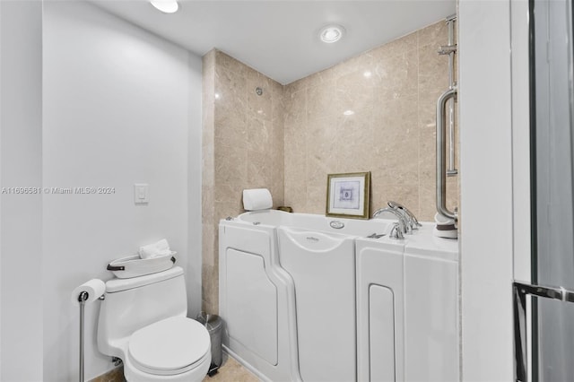 bathroom with a bathing tub and toilet