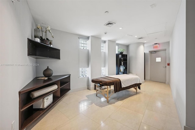 bedroom with light tile patterned floors