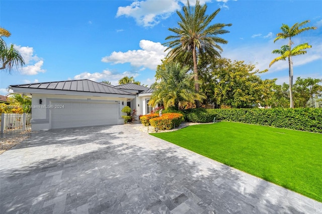 view of front facade featuring a front lawn and a garage