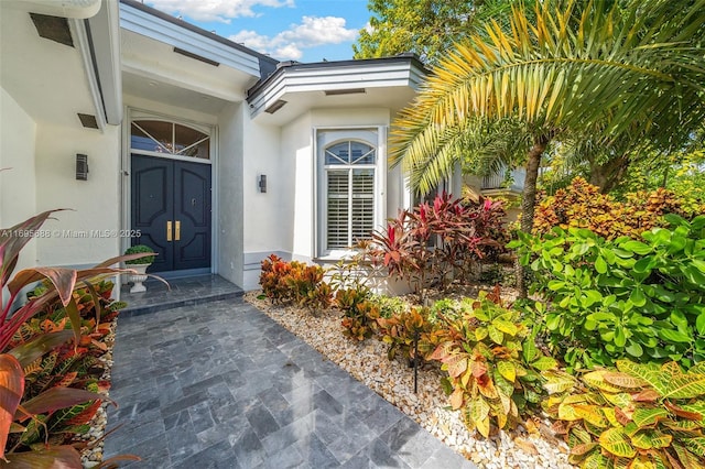 property entrance with stucco siding