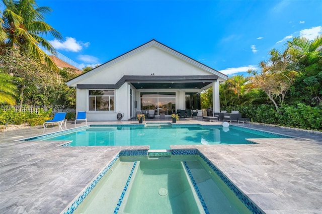 view of pool with an in ground hot tub and a patio area