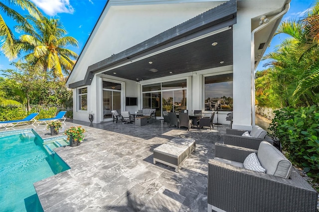 rear view of house featuring an outdoor hangout area and a patio