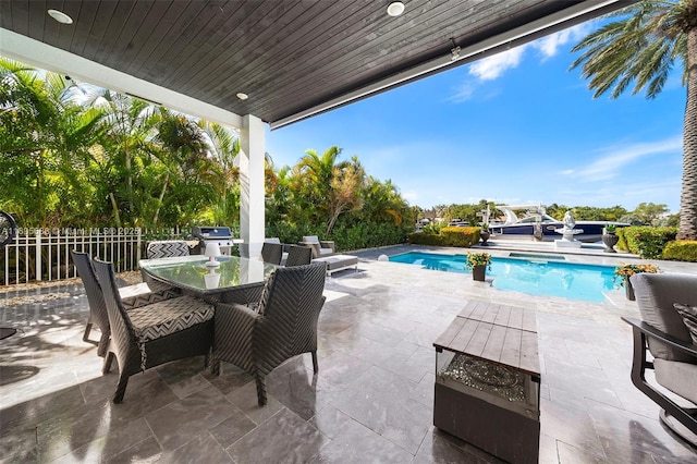 pool with outdoor dining space and a patio area