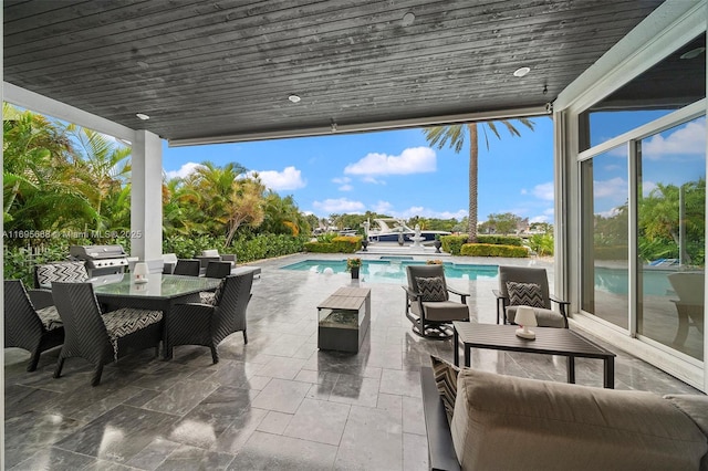 view of patio with an outdoor pool, outdoor lounge area, area for grilling, and outdoor dining space