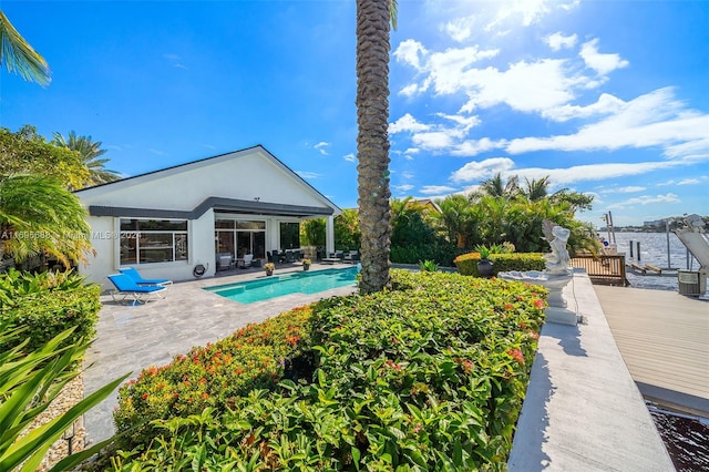 view of pool featuring a patio area and a deck with water view