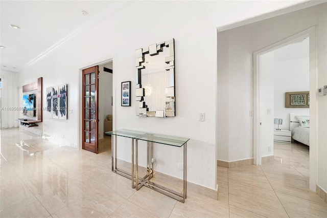 corridor featuring baseboards and crown molding