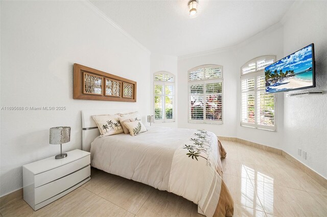 bedroom featuring light tile patterned floors and crown molding