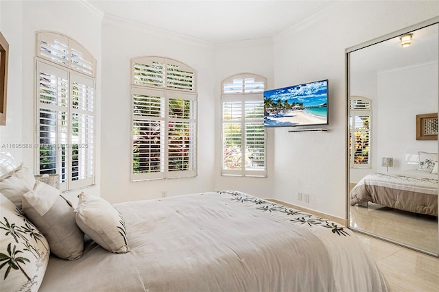 bedroom with crown molding, baseboards, and tile patterned floors