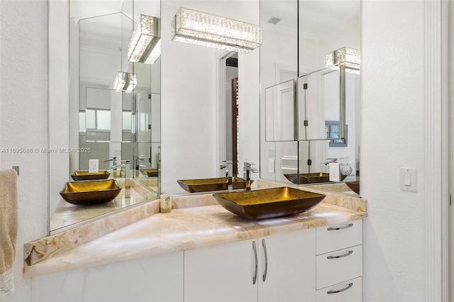 bathroom featuring visible vents and vanity