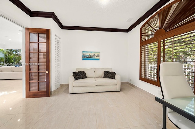 tiled living room featuring ornamental molding and a textured ceiling