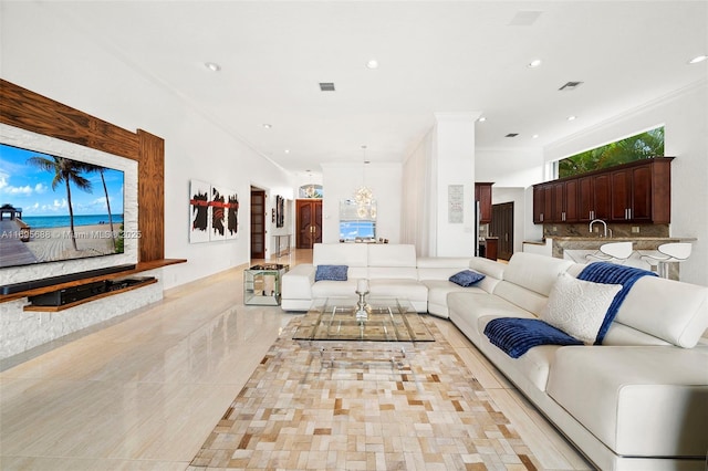 living room with visible vents, ornamental molding, and recessed lighting