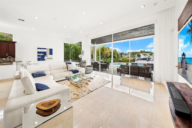 living room with light tile patterned floors and a water view