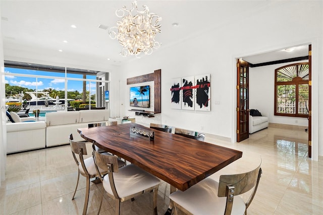 tiled dining space featuring a notable chandelier and ornamental molding