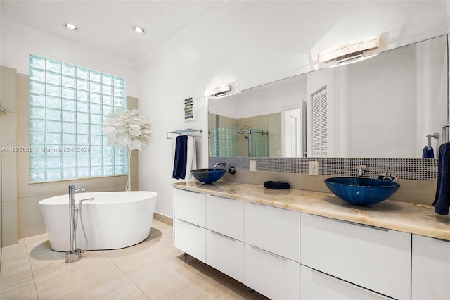 bathroom with tile patterned flooring, ornamental molding, vanity, and independent shower and bath