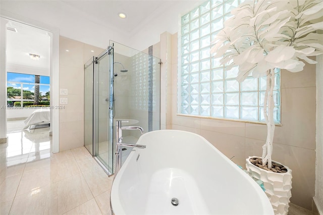 bathroom with tile patterned floors, plenty of natural light, ornamental molding, and shower with separate bathtub