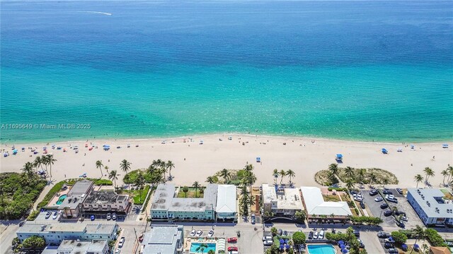 drone / aerial view with a water view and a view of the beach