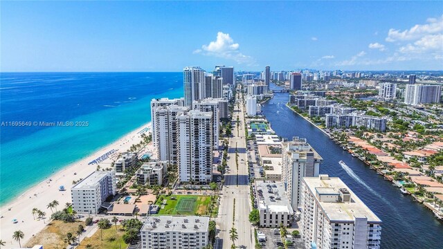 drone / aerial view with a water view and a view of the beach