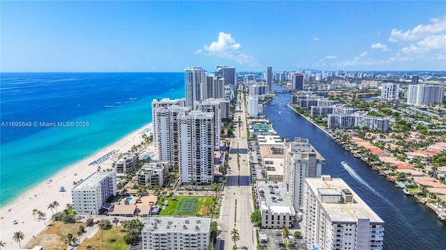 bird's eye view featuring a water view and a beach view