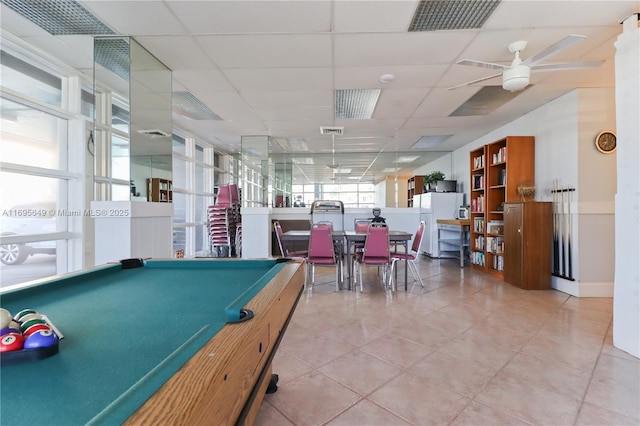 recreation room with a drop ceiling, tile patterned floors, and ceiling fan