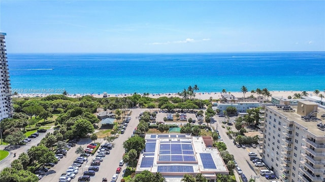 drone / aerial view featuring a beach view and a water view