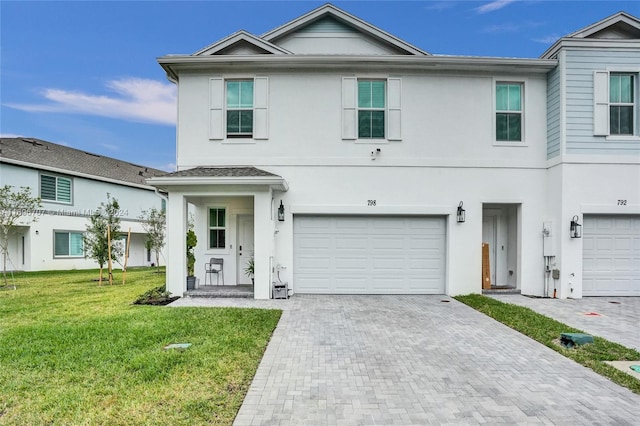 view of front facade with a garage and a front lawn