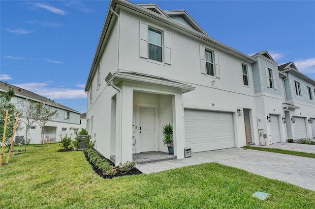 view of front of property with a front yard and a garage