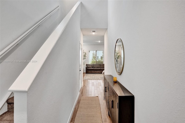 corridor with light hardwood / wood-style floors