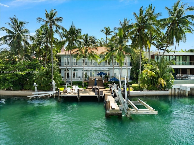 dock area featuring a balcony and a water view