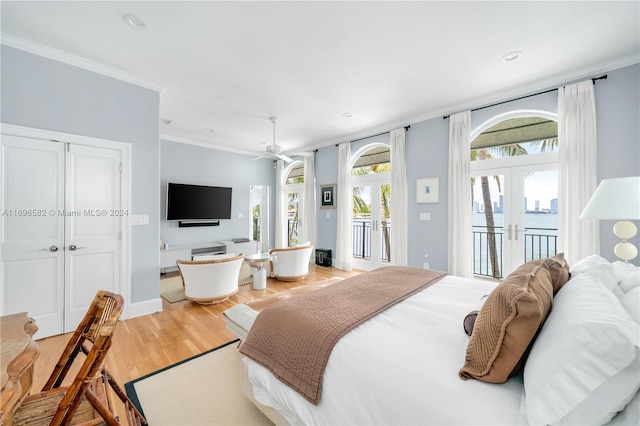 bedroom featuring access to outside, crown molding, french doors, and hardwood / wood-style flooring