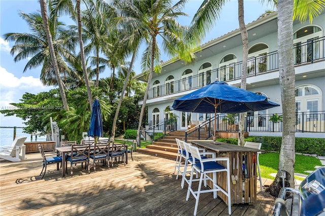 wooden terrace with a grill and exterior bar