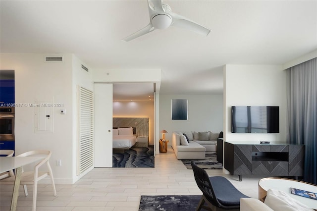 living room featuring ceiling fan and light hardwood / wood-style flooring