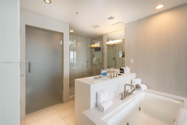 bathroom featuring separate shower and tub, tile patterned flooring, tile walls, and sink