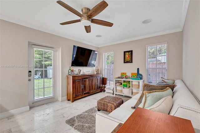 living room featuring ceiling fan, ornamental molding, and a wealth of natural light