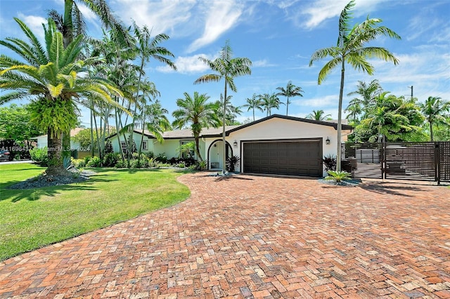 ranch-style home with a garage and a front lawn