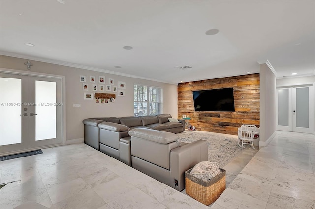 living room with wood walls, french doors, and crown molding