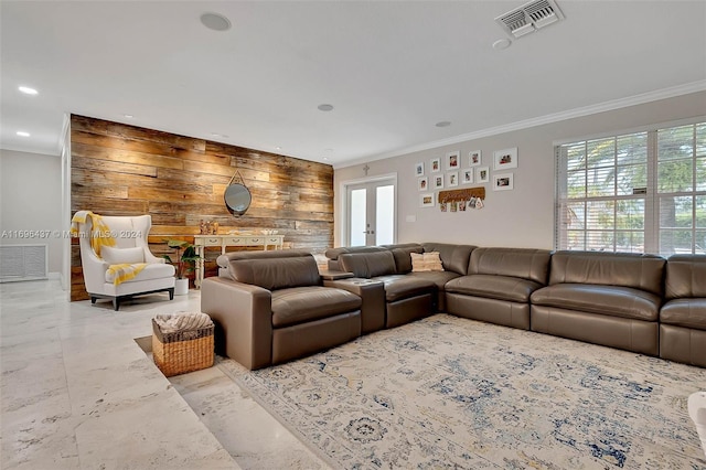 living room with french doors, crown molding, and wood walls