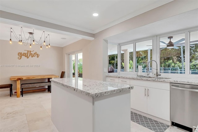 kitchen with a center island, dishwasher, sink, plenty of natural light, and white cabinets