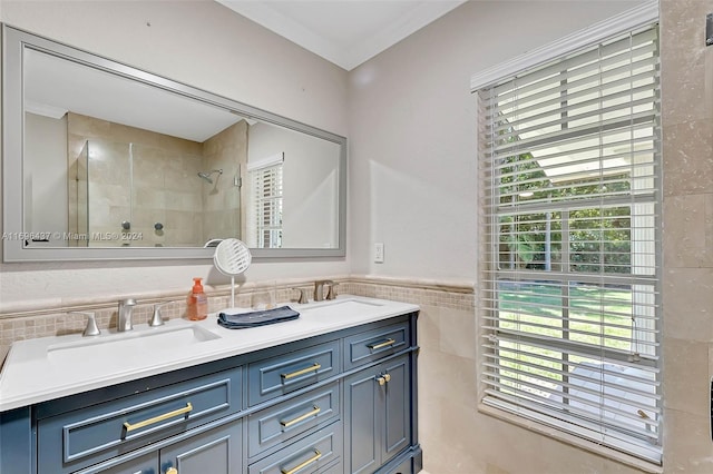 bathroom featuring vanity, a healthy amount of sunlight, tile walls, and tiled shower