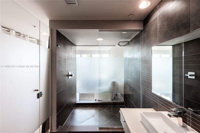 bathroom featuring tile patterned flooring, tile walls, and a healthy amount of sunlight