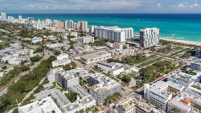 birds eye view of property featuring a water view and a view of the beach