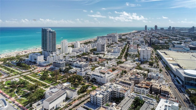 birds eye view of property featuring a beach view and a water view