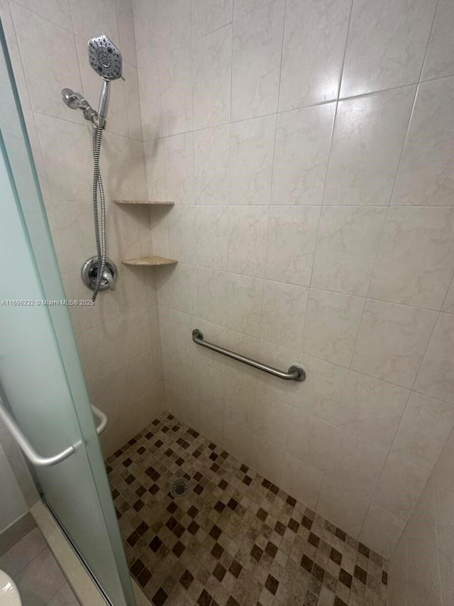 bathroom featuring a shower with door