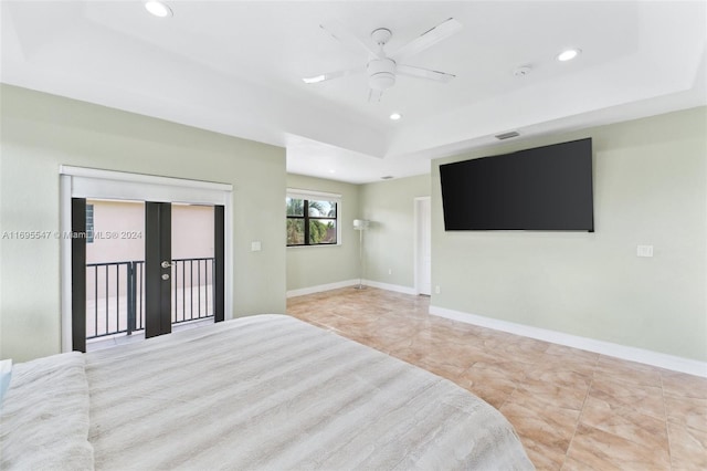 bedroom featuring access to exterior, french doors, a raised ceiling, and ceiling fan