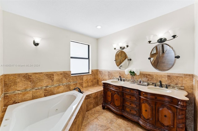 bathroom featuring tile patterned flooring, vanity, and a relaxing tiled tub